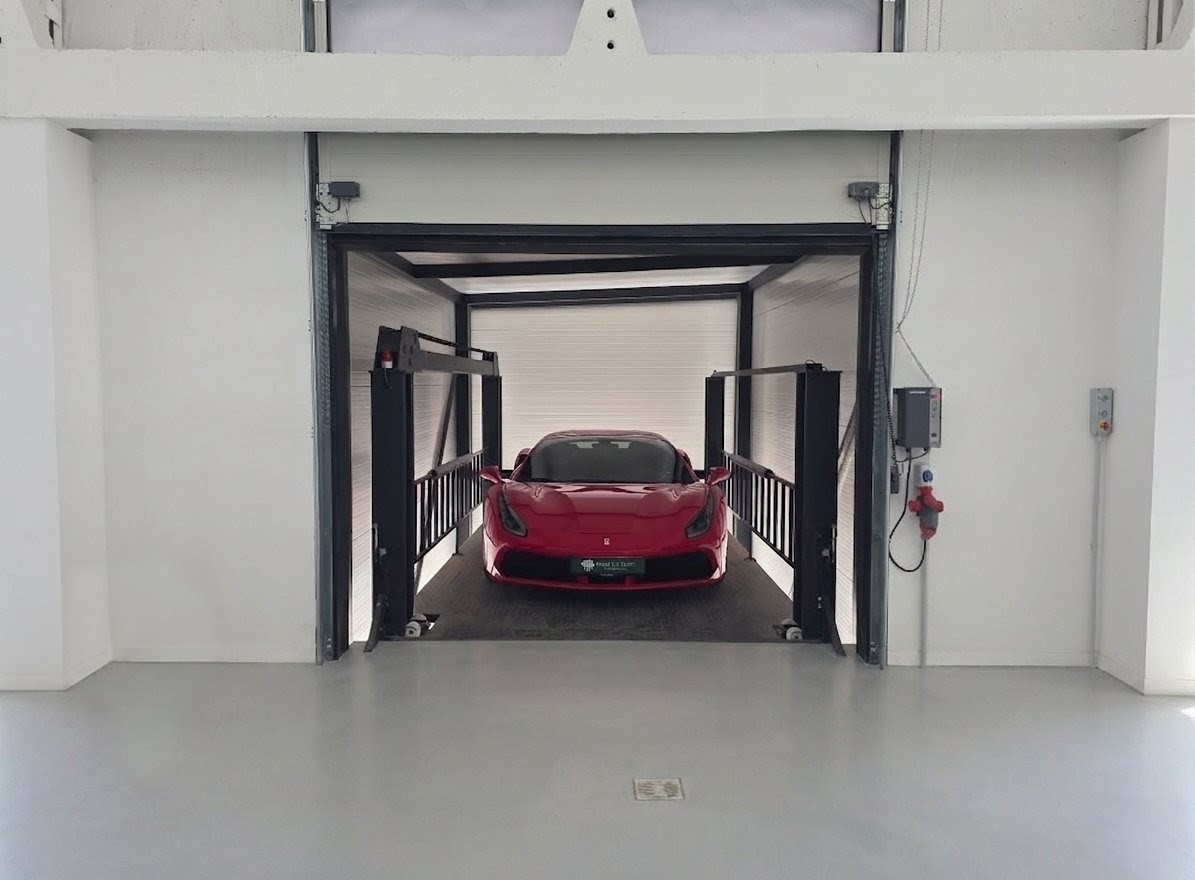 Ferrari stored in a professional hydraulic lift elevator